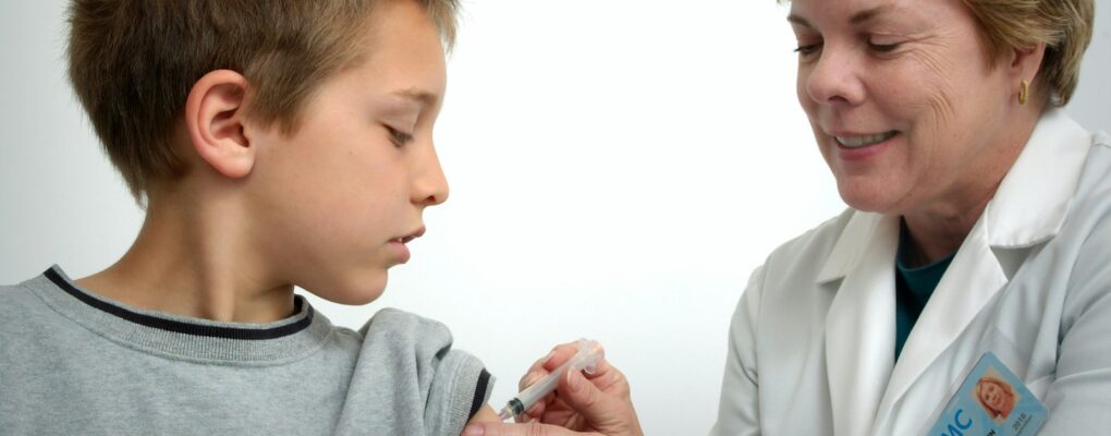 woman inject boy on arm